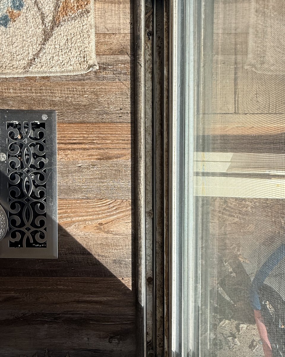 Window frame before cleaning, grime along the track edge